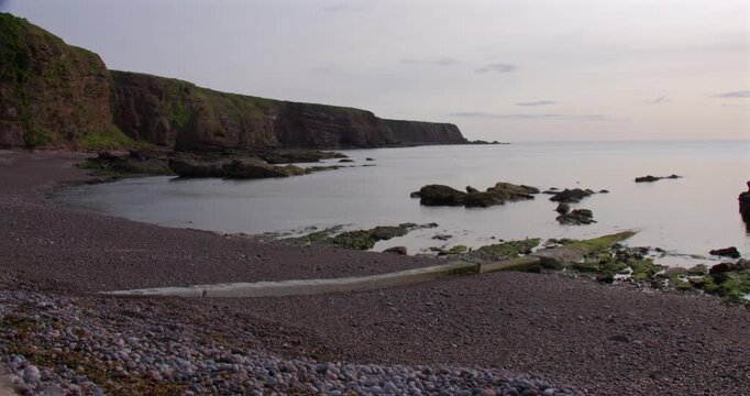 Extra Wide shot of the old harbour clifs and beach at Auchmithie, Arbroath