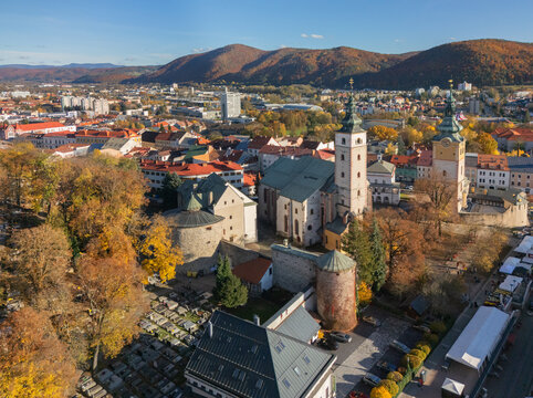 Aerial view of the historic town square and the iconic Church of the Assumption of the Virgin Mary amidst autumn foliage, Banska Bystrica, Banska Bystrica Region, Slovakia.
