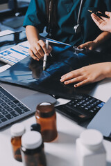 Group of doctors attending seminar in hospital lecture hall with senior physician giving medical...