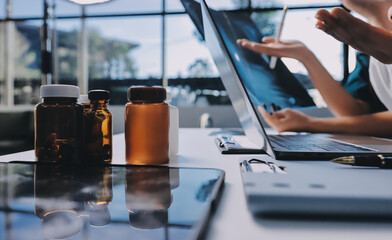 Group of doctors attending seminar in hospital lecture hall with senior physician giving medical...