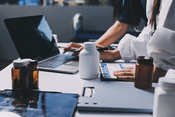 Group of doctors attending seminar in hospital lecture hall with senior physician giving medical...