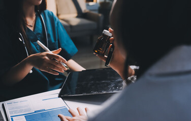 Group of doctors attending seminar in hospital lecture hall with senior physician giving medical...