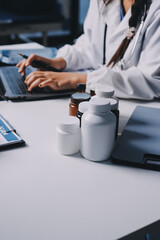 Group of doctors attending seminar in hospital lecture hall with senior physician giving medical...