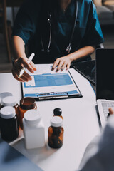 Group of doctors attending seminar in hospital lecture hall with senior physician giving medical...