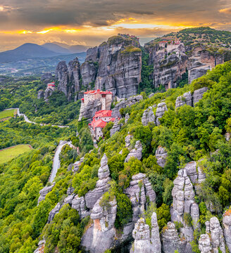 Aerial view of monasteries perched atop towering rock formations, a blend of nature's grandeur and human endeavor, Kalabaka, Trikala, Greece.