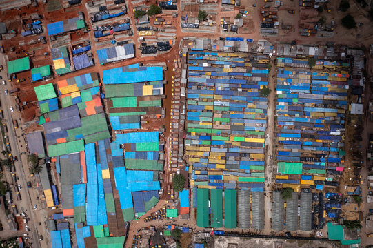 Aerial view of densely packed buildings with vibrant blue, green, and orange roofs creating a mosaic pattern from above, Dhaka, Dhaka Division, Bangladesh.