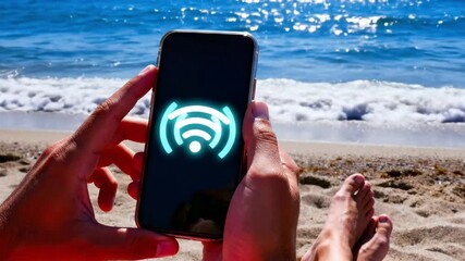 Person holding a phone with a wifi signal icon on a sunny beach. Animated internet connection symbol on a smartphone by the ocean. Remote work and digital nomad lifestyle concept - Powered by Adobe