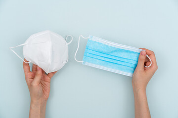 Holding two disposable medical masks and making a choice