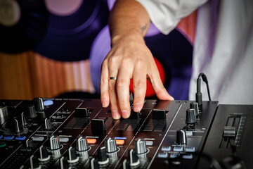 DJ adjusting audio mixer during event