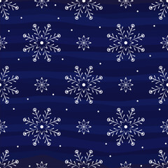 White beautiful snowflakes ona blue background. Winter pattern. Seamless vector image