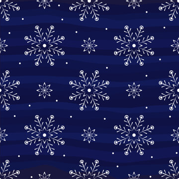 White beautiful snowflakes ona blue background. Winter pattern. Seamless vector image