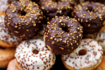 Chocolate and vanilla donuts with nuts topping