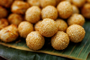 Golden sesame balls on banana leaf
