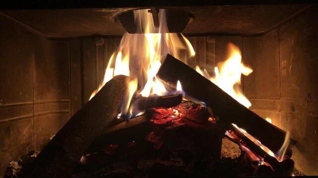 Fire Burning in a Fireplace on a Winter Evening. Horizontal Video