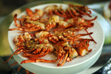 Grilled lobster halves served on white plate