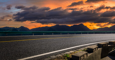 Asphalt highway road and mountain with beautiful sky clouds at sunrise
