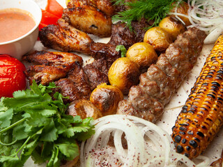 Various types of meat cooked over an open fire