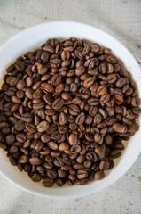 Abundance of Roasted Coffee Beans in White Bowl, Overhead View