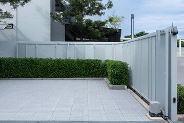 A light automatic sliding gate with a drive motor installed at the base.