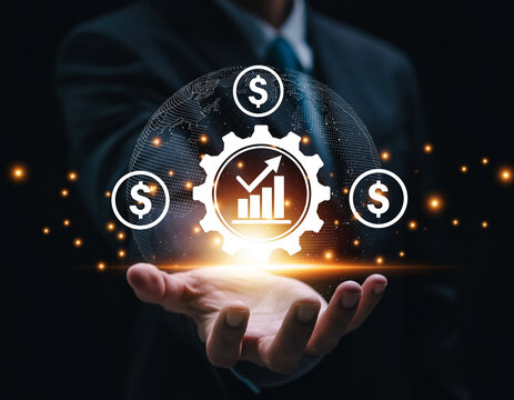 Businessman holding a glowing digital interface with a gear, growth chart, and dollar signs, symbolizing financial success and strategy.