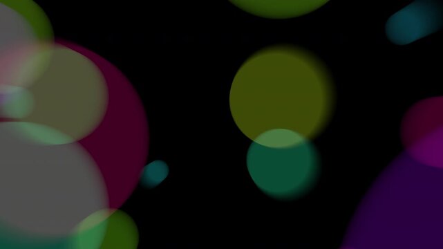 Soft Blurry Circular coloured bokeh bubbles floating on blackspace