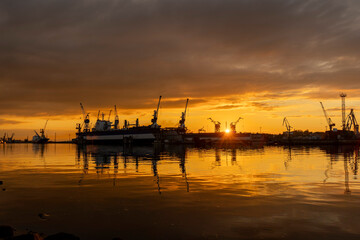 Beautiful industrial sunset scenery at the harbour. Riga, Latvia.