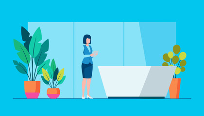 Businesswoman working at a modern office reception desk in a lobby with plants