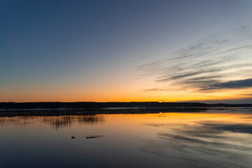 Beautiful autumn morning landscape of a lake before the runrise. Seasonal scenery in Riga, Latvia.