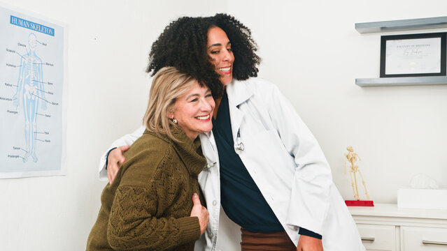 Compassionate Doctor Embracing Patient In Clinic, Warm Health Care Moment Of Support And Care Together