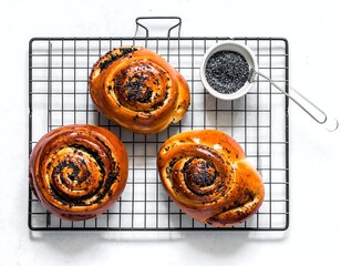 Overhead shot of golden-brown poppy seed rolls on a wire rack