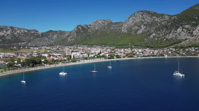Aerial drone video of the &Ouml;ren Neighborhood-Holiday Village in the Milas district of Muğla province in T&uuml;rkiye, above the beach and sea, on a sunny day