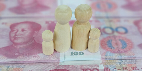 Chinese family figurines of adults and children and yuan money