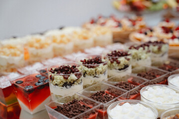 Dessert buffet or candy bar during catering event, fruits and whipped cream