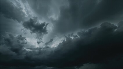 Fototapeta premium Dark grey cumulus clouds creating a stormy sky texture with thunderstorm