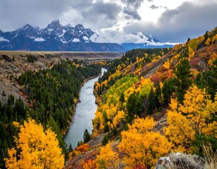 Scenic river winding through colorful fall foliage beneath majestic mountains