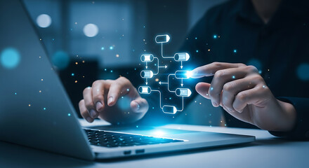 Businessman pointing at flowchart on laptop screen illustrating workflow process and automation.