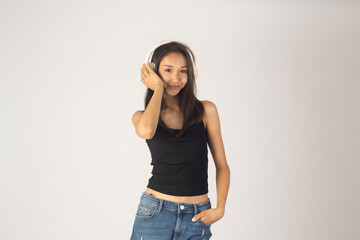 Young woman is listening to music through headphones