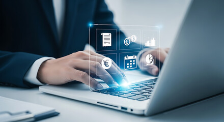 Businessman using laptop with virtual interface displaying finance and business icons, planning and managing finances