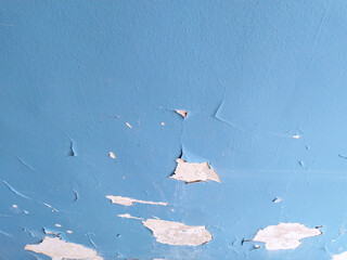 Old domestic room. residential building. Cracked blue paint on peeled wall. Cleaning. Peeling off...