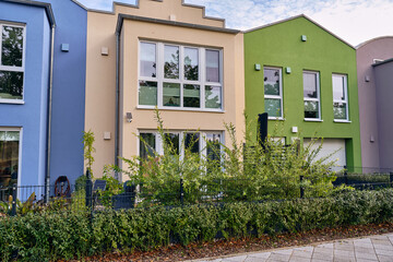 Obraz premium Colorful modern row houses with clean lines and bright facades in Wismar, Germany, highlighting minimalistic architecture and sustainable urban housing