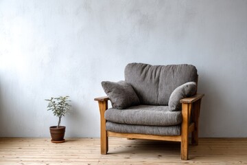 Comfortable upholstered wooden armchair sits against a textured light wall beside a small potted plant