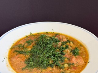 Braised potatoes with green peas, meat, and fresh dill. Delicious home cooking.