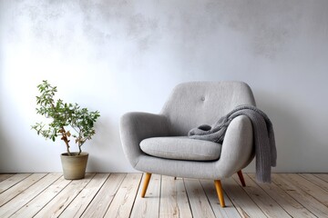 Minimalist interior setting features a light gray upholstered armchair beside a potted houseplant against a textured white wall