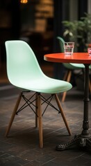 Light blue modern chair at an orange bistro table outdoors in a cafe setting