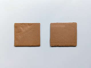 Two Cardboard Pieces Isolated side-by-side on a clean white background. This Cardboard Pieces Isolated photo is perfect for minimalist comparison mockups.