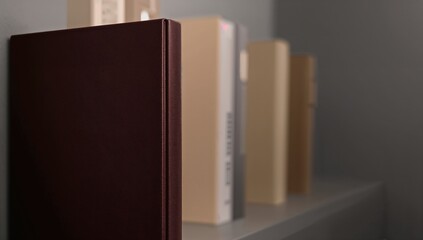 Fototapeta premium Book stacked on a shelf, suitable for educational layout,