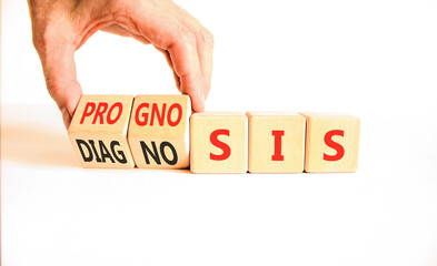 Prognosis or diagnosis symbol. Concept words Prognosis or Diagnosis on beautiful wooden blocks. Beautiful white background. Doctor's hand. Business prognosis or diagnosis concept. Copy space.