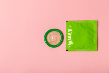 Condoms on a colored background. Colorful fruit-themed condoms in packaging. Safe sex concept....