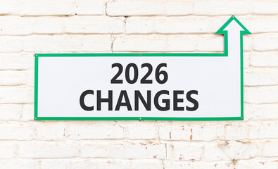 2026 Changes symbol. Concept words 2026 Changes on beautiful white sign with arrow. Beautiful old white brick wall background. Business and 2026 changes concept. Copy space.