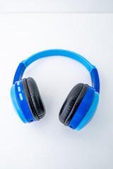 Bright blue wireless children's headphones shot isolated over a white background.